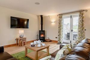 a living room with a couch and a fireplace at 2 Bed in Gilwern oc-o27004 in Gilwern