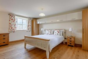 a bedroom with a large white bed and a window at 2 Bed in Gilwern oc-o27004 in Gilwern