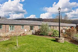 an old stone house with a lamp in the yard at 2 Bed in Gilwern oc-o27004 in Gilwern