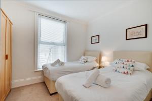 two beds in a room with a window at 2 Bed in Seaton oc-mbbri in Seaton