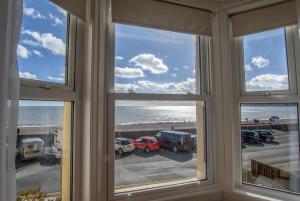 a room with windows looking out at the beach at 2 Bed in Seaton oc-mbbri in Seaton +4 photos