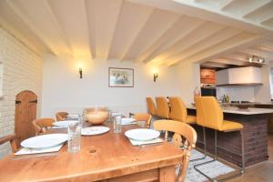a dining room with a wooden table and chairs at 4 Bed in Seaton oc-s27403 in Seaton