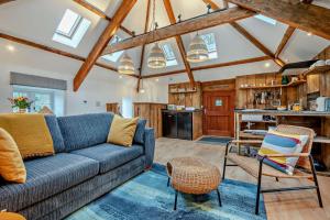 a living room with a blue couch and a kitchen at 1 Bed in Werrington oc-c29073 in Werrington