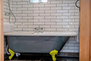 a bath tub in a bathroom with a white brick wall at 1 Bed in Werrington oc-c29073 in Werrington +18 photos