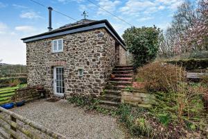 an old stone house with stairs in a garden at 1 Bed in Werrington oc-c29073 in Werrington