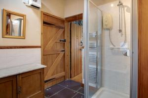 a bathroom with a shower with a glass door at 2 Bed in Caernarfon oc-wag263 in Llandegfan +16 photos