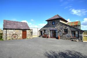 an old stone building with a large driveway at 2 Bed in Caernarfon oc-wag263 in Llandegfan