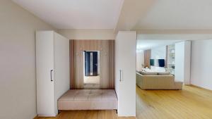 a living room with white walls and wooden floors at Vila MUJE in Belsh