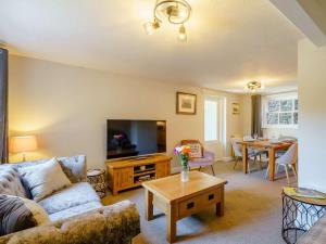 a living room with a couch and a table at 2 Bed in Sedbergh oc-89266 in Milnthorpe