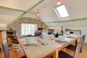 a dining room with a large wooden table and chairs at 3 Bed in Beer oc-jbgall in Beer +16 photos