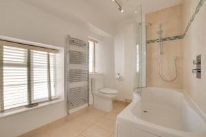 a bathroom with a tub and a toilet and a shower at 3 Bed in Beer oc-jbgall in Beer