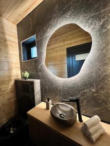 a bathroom with a sink and a mirror at Carpathic Chalet in Comandău +21 photos