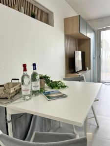 two bottles of wine on a white table in a kitchen at Studio face plage / centre ville in Arcachon