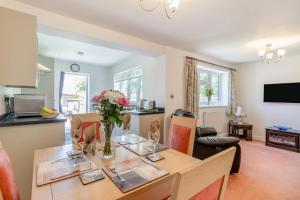 a dining room with a table with a vase of flowers at 1 Bed in Halam oc-o32227 in Edingley