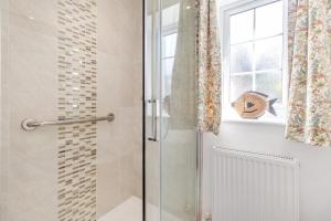 a shower with a glass door in a bathroom at 1 Bed in Halam oc-o32227 in Edingley +9 photos