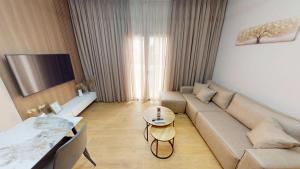 a living room with a couch and a table at Vila MUJE in Belsh