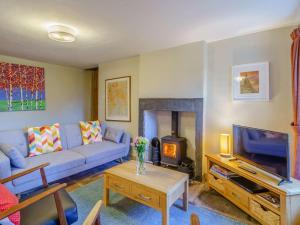 a living room with a blue couch and a tv at 2 Bed in Cockermouth oc-86023 in Lorton
