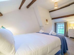 a bedroom with a large white bed with two towels on it at 2 Bed in Cockermouth oc-86023 in Lorton