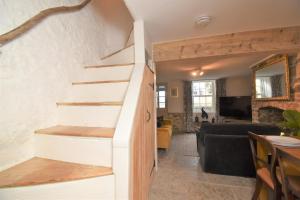 a staircase in a living room with a couch and a table at 2 Bed in Seaton oc-b27402 in Seaton