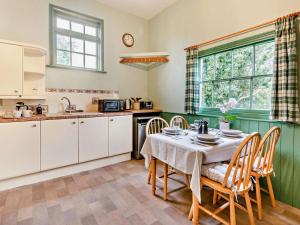 a kitchen with a table and chairs and a kitchen with a sink at 2 Bed in Alford oc-94226 in Great Carlton +13 photos