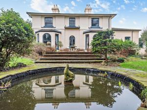 a house with a pond in front of it at 2 Bed in Alford oc-94226 in Great Carlton