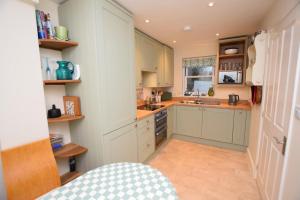 a kitchen with white cabinets and a sink at 2 Bed in Seaton oc-mbtuc in Seaton