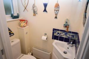 a small bathroom with a toilet and a sink at 2 Bed in Seaton oc-mbtuc in Seaton +12 photos