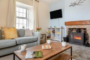 a living room with a couch and a fireplace at 2 Bed in Berwick-upon-Tweed oc-l32027 in Kyloe