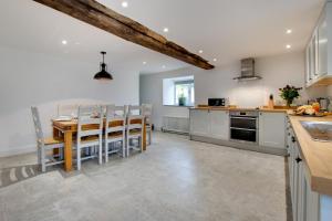 a kitchen and dining room with a table and chairs at 4 Bed in Ruthin oc-bow136 in Gwyddelwern