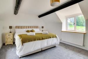 a bedroom with a large bed and a window at 4 Bed in Ruthin oc-bow136 in Gwyddelwern