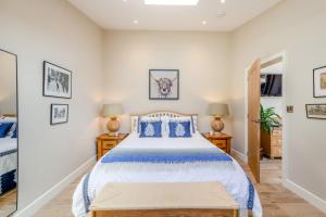 a bedroom with a large bed with blue pillows at 1 Bed in Ashton oc-p30484 in Ashton