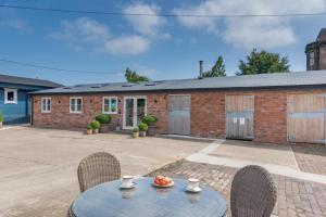 a patio with a table and chairs and a building at 1 Bed in Ashton oc-p30484 in Ashton