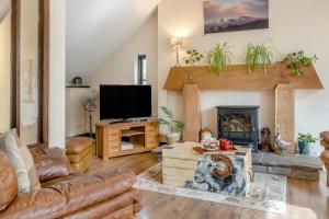 a living room with a couch and a fireplace at 2 Bed in Trallong oc-bow106 in Sennybridge