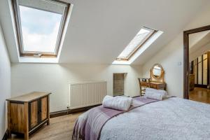 a bedroom with a bed and two skylights at 2 Bed in Trallong oc-bow106 in Sennybridge