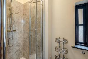 a shower with a glass door in a bathroom at 2 Bed in Trallong oc-bow106 in Sennybridge +23 photos