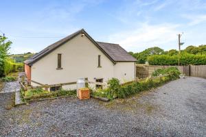a white house with a fence in front of it at 2 Bed in Trallong oc-bow106 in Sennybridge