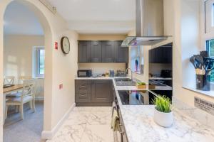 a kitchen with a counter with a sink and a stove at 3 Bed in Southwell oc-s30603 in Southwell
