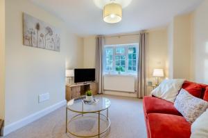 a living room with a red couch and a glass table at 3 Bed in Southwell oc-s30603 in Southwell