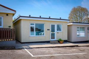 a house with a car parked in a parking lot at 2 Bed in Brixham oc-f28884 in Brixham