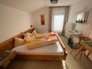 a bedroom with a large bed and a sink at Ferienhaus Greti Ehrwald in Ehrwald +20 photos