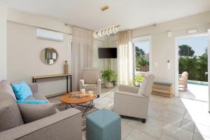 a living room with a couch and a table at Thalia by Vintage Travel in Agios Georgios