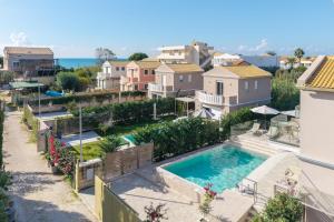 arial view of a house with a swimming pool at Thalia by Vintage Travel in Agios Georgios