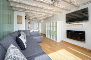 a living room with a gray couch and a tv at 2 Bed in Pwllheli oc-glanab in Abersoch