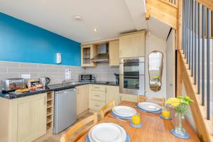 a kitchen with a wooden table with two chairs and a dining room at 1 Bed in Berwick-upon-Tweed oc-b32029 in Kyloe +14 photos