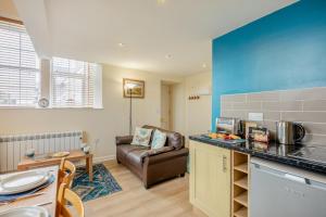a kitchen and living room with a couch and a table at 1 Bed in Berwick-upon-Tweed oc-b32029 in Kyloe