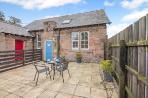 a patio with a table and chairs in front of a house at 1 Bed in Berwick-upon-Tweed oc-b32029 in Kyloe
