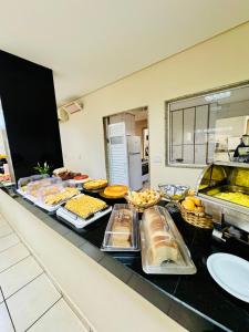 a buffet line with many different types of food at Copaiba Palace Hotel in Bauru