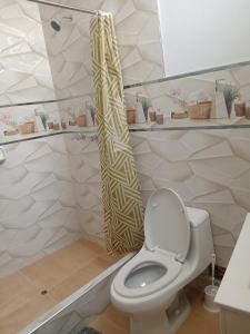 a bathroom with a toilet and a shower at La Casa Del Hombre in Puerto Chicama