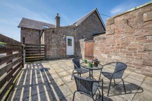 a patio with a table and chairs in front of a building at 1 Bed in Berwick-upon-Tweed oc-c32028 in Kyloe