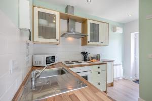 a kitchen with a sink and a microwave at 1 Bed in Berwick-upon-Tweed oc-c32028 in Kyloe +18 photos